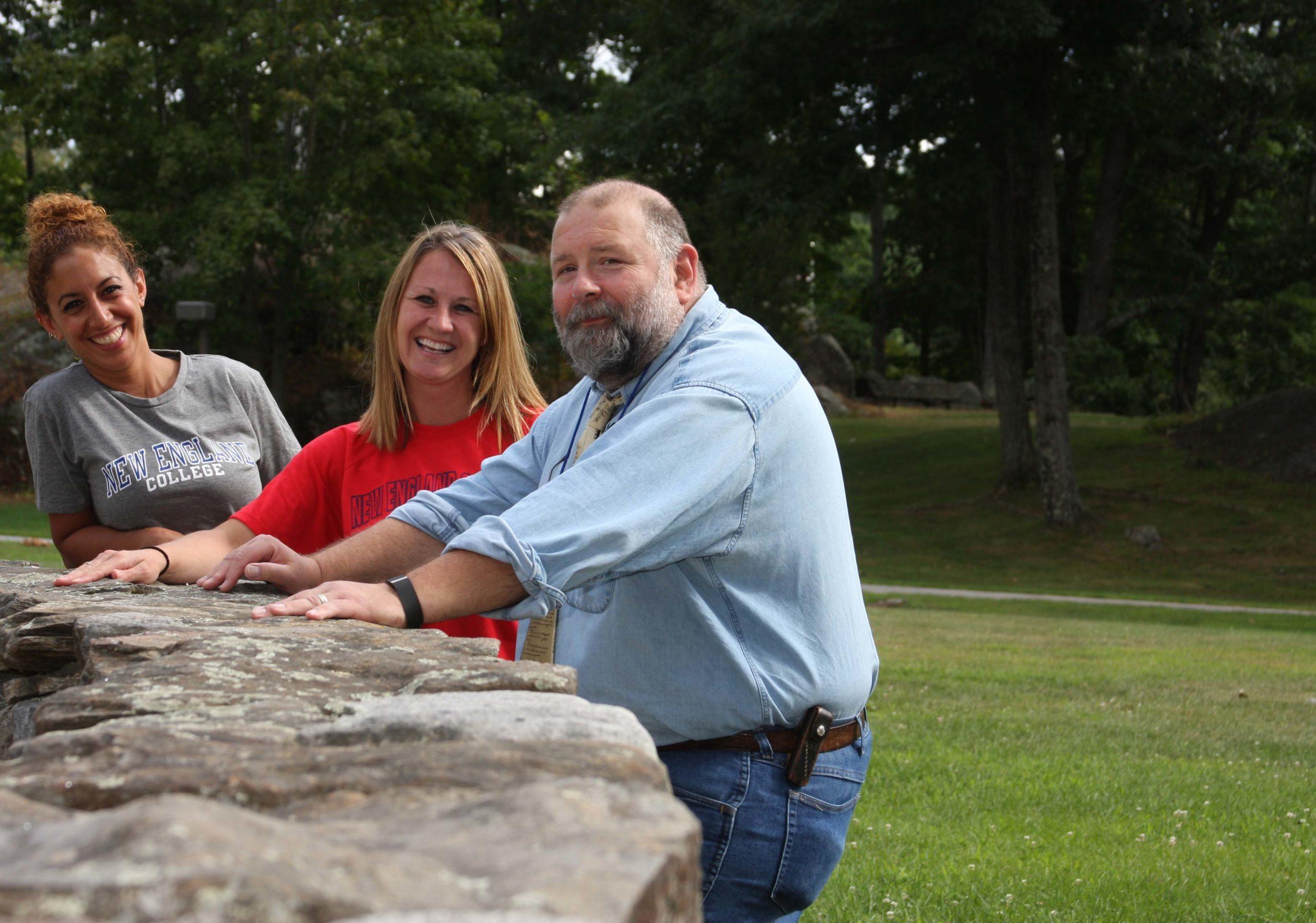 Three undergraduate faculty members outside in Henniker